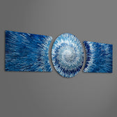An abstract 3D starburst of blue and silver shards radiating outward from a bright glowing white center. 3 piece glass wall art set F