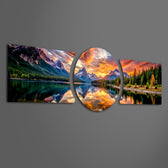 Snow-capped mountains and pine forests glowing under a fiery orange sunset, mirrored in a still mountain lake. 3 piece glass wall art set F