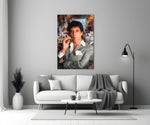 Close-up detail of Tony Montana with gold Uzi behind glass