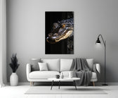 Close-up detail of the alligator and amber eye behind glass