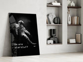 Astronaut panel against a moody dark-painted accent wall