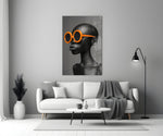 Close-up detail of bald female bust with tangerine sunglasses behind glass