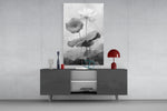Black and White Water Lily glass wall art catching light to reveal its painted petals