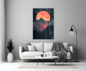 Close-up detail of red-orange moon over peaks behind glass
