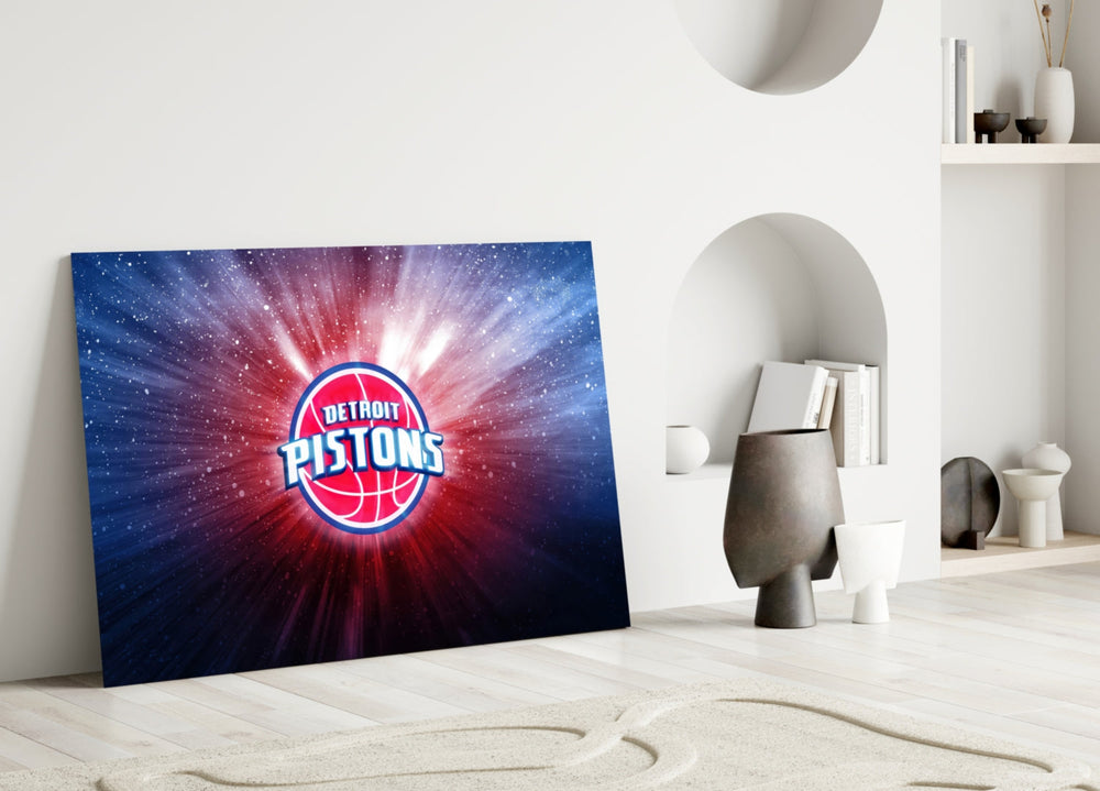 Close-up detail of Pistons logo with cosmic burst behind glass