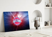 Close-up detail of Pistons logo with cosmic burst behind glass