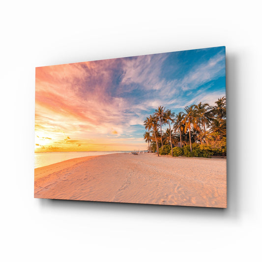 Sunset palm beach tropical glass wall art above linen sofa in coastal living room
