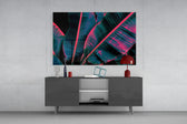 Stage-lit tropical leaf glass wall art in nightclub-style home bar
