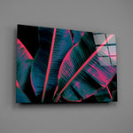 Teal-and-pink tropical foliage glass wall art over modern living-room sofa