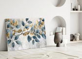 Painterly leaf-branch cinematic glass wall art over linen sofa in designer lounge