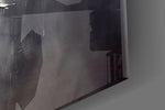 Graphite-and-gold feather glass wall art in boutique-hotel lounge