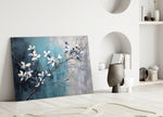 Cottony-blossom painterly glass wall art over linen sofa in designer lounge