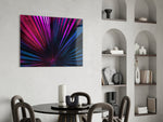 Stage-lit palm-fan cinematic glass wall art over master-bedroom headboard