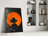Black-and-orange cinematic glass wall art over modern dining sideboard