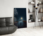 Rain-slick road cinematic glass wall art over modern dining sideboard