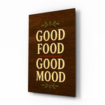 Good Food Good Mood walnut cinematic glass wall art over walnut console in designer kitchen