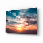 Sunset cloudscape cinematic glass wall art over walnut console in designer hotel-resort lobby