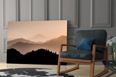 Mountains artwork anchoring a wall with serene warm palette