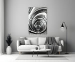 Loop glass wall art styled above a bench in a stairwell