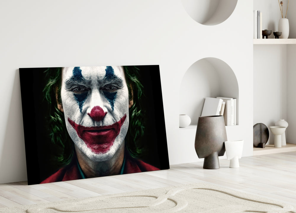 Joker glass wall art styled above a desk in a man's office