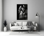 Feather glass wall art styled above a bed in a bedroom