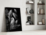 Feather artwork anchoring a wall with moody serene palette