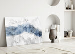 Ink Drift glass wall art styled above a console in a modern foyer