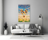 Balloons glass wall art styled above a bed in a child's room