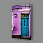 Close-up detail of teal door panels in violet stucco