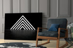 Triangle artwork anchoring a wall with moody modern palette