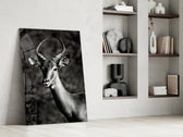 Impala artwork anchoring a wall with moody naturalist palette