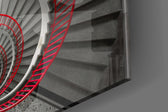 Red Spiral panel catching gallery light to reveal its tactile geometry