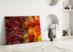 Autumn Leaves glass wall art styled above a sofa in a living room