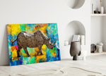 Color Splash Rhino glass wall art styled above a desk in a man's office