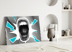 Scream glass wall art styled above a desk in a creative office