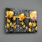 Close-up detail of gold-yellow rose against grey wood