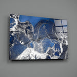 Close-up detail of ivory spill cutting through cobalt clouds