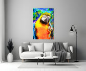Macaw Bloom glass wall art styled above a sofa in a living room