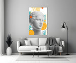 Venus Collage glass wall art styled above a sofa in a living room