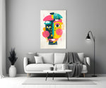 Pop Face glass wall art styled above a sofa in a creative office