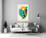 Amber Face glass wall art styled above a credenza in a creative office