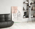 Line Monstera glass print enhancing a bedroom with editorial drama