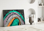 Selmin Arcs glass wall art styled above a sofa in a creative office