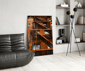 Orange Stairs glass print enhancing a man's office with cinematic drama