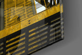 Yellow Stairs panel catching window light to reveal its tactile rivet