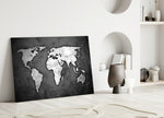 Grunge World Map glass wall art styled above a sofa in a man's office
