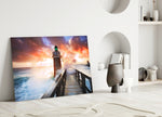 Sunset Lighthouse glass wall art styled above a console in a living room