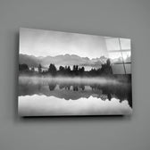 Misty Lake close-up showing forest silhouette mirrored across calm water