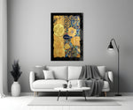 Golden Klimt glass wall art styled above a sofa in a living room