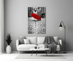 Red Umbrella glass wall art styled above a console in a hallway